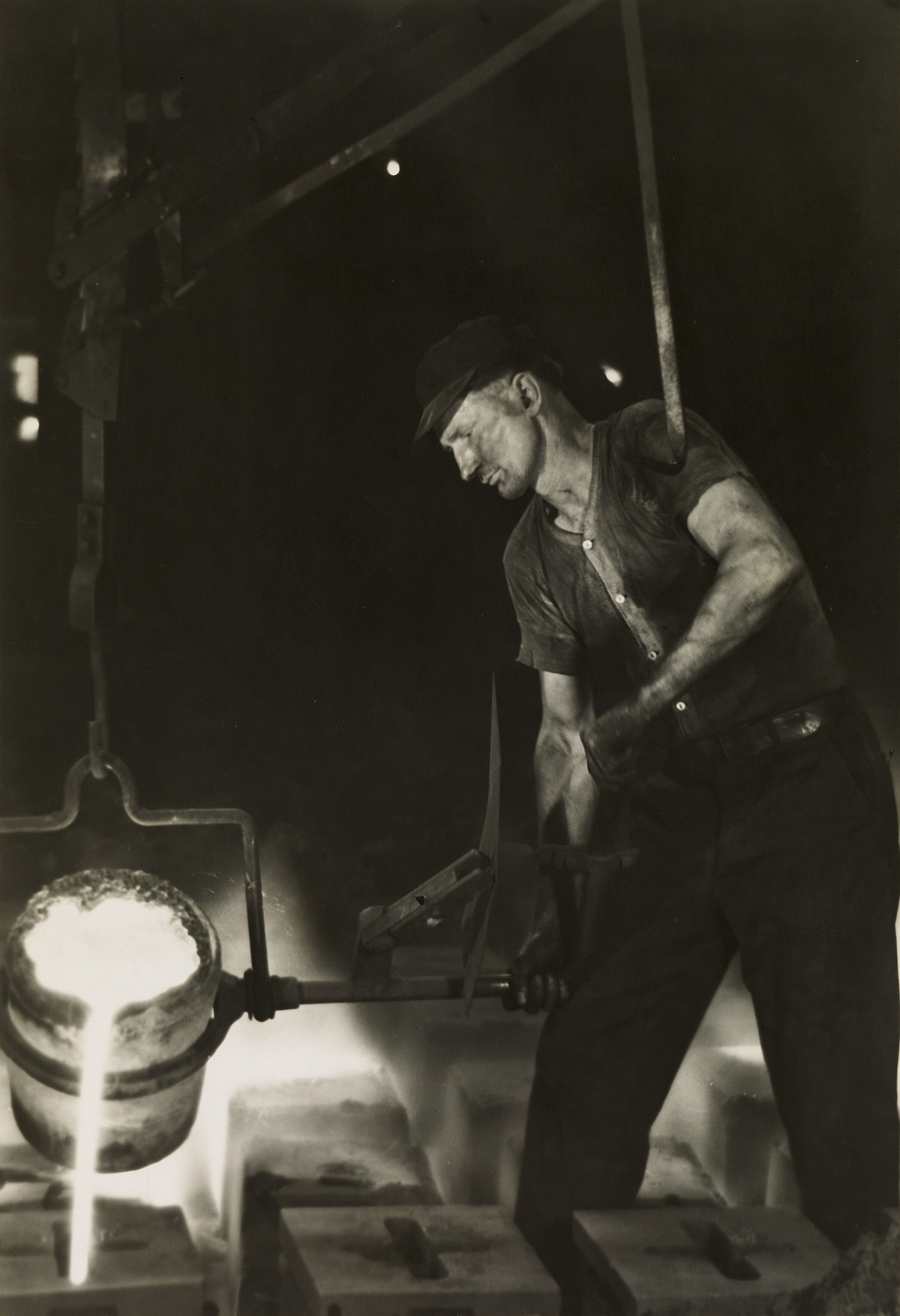 MARGARET BOURKE-WHITE (1904-1971) Pouring molten metal into ingot molds, Ludlum Steel Co.
